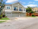 Well-maintained townhome features multiple car garages and attractive landscaping at 1933 Estancia Cir, Kissimmee, FL 34741