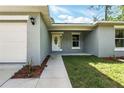 Home's charming entryway with well maintained landscaping and a bright exterior at 225 Starling Ct, Kissimmee, FL 34759