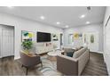 Staged living room featuring modern decor, recessed lighting, and lots of natural light at 225 Starling Ct, Kissimmee, FL 34759