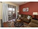 Comfortable living room offers a sliding door to a private balcony overlooking the neighborhood at 2301 Butterfly Palm Way # 303, Kissimmee, FL 34747