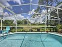 Relaxing poolside view showcasing a sparkling pool with a scenic outdoor view at 2408 Saint Augustine Blvd, Haines City, FL 33844