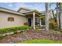 Charming front porch area with lush landscaping and cozy seating at 247 Bell Tower Xing W, Poinciana, FL 34759