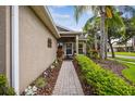 Inviting front entrance with landscaped walkway and decorative accents at 247 Bell Tower Xing W, Poinciana, FL 34759