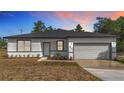 Charming single-story home featuring a one car garage and a neatly maintained front yard with a fresh, modern aesthetic at 2639 Sw 162Nd Street Rd, Ocala, FL 34473