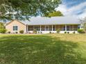 Picture-perfect exterior showcasing a well-maintained lawn, landscaping, and a welcoming screened front porch at 3048 Cherokee Rd, St Cloud, FL 34772