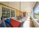 Relaxing screened front porch with porch swing and ample seating to enjoy the outdoors at 3048 Cherokee Rd, St Cloud, FL 34772