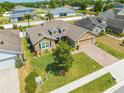 Aerial view of the single-story home featuring a well-manicured lawn and brick driveway at 3101 Drema Dr, St Cloud, FL 34769