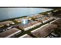 Aerial view of lakeside community with carports and well-maintained landscaping next to the lake at 344 Winter Ridge Blvd # 344, Winter Haven, FL 33881