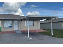 Single-story home with a convenient carport, stucco siding, and a brick parking area at 344 Winter Ridge Blvd # 344, Winter Haven, FL 33881