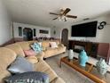 Comfortable living area featuring tile floors, a ceiling fan and a view into the dining area at 344 Winter Ridge Blvd # 344, Winter Haven, FL 33881