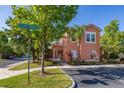 View of a charming home featuring tropical landscaping, a visible street sign, and easy access at 4722 Flagler Beach Way, Kissimmee, FL 34746