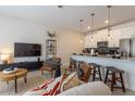 Stylish living room with modern decor and open floor plan to kitchen at 4835 Memories Ln, Kissimmee, FL 34746