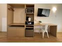 Bedroom cabinet featuring a mini fridge, safe, microwave, and desk at 5245 W Irlo Bronson Memorial Hwy # 210, Kissimmee, FL 34746