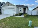 Beautiful single-Gathering home with a well-maintained lawn and a two-car garage at 6783 Grace Hammock Rd, Harmony, FL 34773