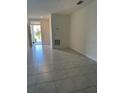 Inviting living room with light grey tiled flooring and a bright, airy atmosphere at 6783 Grace Hammock Rd, Harmony, FL 34773