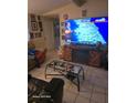 Comfortable living room with modern fireplace, TV, and neutral tile flooring at 7511 Us Highway 98 N, Lakeland, FL 33809