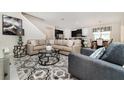 Spacious living room with stylish furniture and decor, seamlessly connected to the kitchen and dining area at 9038 Pelican Cove Trce, Kissimmee, FL 34747