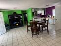Spacious living room and dining area with tile floors and open concept layout at 98 Orange Park Blvd, Lake Wales, FL 33898