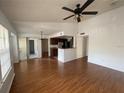Open-concept living room featuring wood floors, ceiling fan, and view of the kitchen at 1027 S Hiawassee Rd # 2323, Orlando, FL 32835