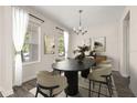 Elegant dining room featuring modern decor, stylish light fixture, and large windows at 11843 Fiction Ave, Orlando, FL 32832