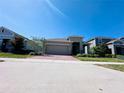 Inviting home with a two-car garage, manicured lawn, and a brick driveway at 1321 Yorkdale Rd, Davenport, FL 33837
