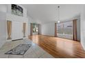 Bright living room features wood floors, large windows, and lots of natural light at 1338 Lake Biscayne Way, Orlando, FL 32824