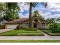 Charming home with a well-manicured lawn, mature trees, and inviting curb appeal at 154 Academy Oaks Pl, Altamonte Springs, FL 32714