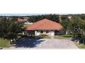 Inviting single story villa with a red tiled roof and well-manicured landscaping at 1558 Cumin Dr, Poinciana, FL 34759
