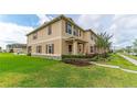 Charming townhome exterior with lush green lawn and inviting curb appeal at 1818 Katz Crossing Dr, Kissimmee, FL 34744