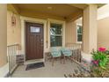 Inviting front porch with seating and decorative accents, perfect for relaxing at 1818 Katz Crossing Dr, Kissimmee, FL 34744
