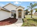 Inviting front entryway with a decorative door and a well-maintained landscape at 1823 Ashton E Dr, St Cloud, FL 34771