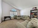 Comfortable living room featuring plush sofas, a window, and a stylish bookshelf at 2365 Paulette Dr, Haines City, FL 33844