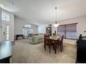 Open-concept living and dining area with vaulted ceilings and lots of natural light at 2365 Paulette Dr, Haines City, FL 33844