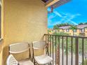 View from the balcony with two chairs and a beautiful blue sky at 247 Verona Ave, Davenport, FL 33897
