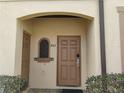 Charming entryway with a secure front door and manicured landscaping, creating a welcoming first impression at 247 Verona Ave, Davenport, FL 33897