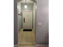 Interior entryway with a tiled floor, modern lighting, and a secure front door at 247 Verona Ave, Davenport, FL 33897