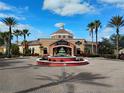 Beautiful Regal Palms Resort exterior with fountain and palm trees under a sunny blue sky at 247 Verona Ave, Davenport, FL 33897