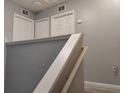 Upstairs hallway with multiple doors, offering privacy and access to various rooms at 247 Verona Ave, Davenport, FL 33897