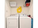Functional laundry room with washer, dryer, and storage shelf for laundry essentials at 2778 Almaton Loop # 403, Kissimmee, FL 34747