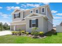 Charming two-story house featuring a three-car garage and a neatly landscaped front yard at 2821 Cathy Blvd, Winter Haven, FL 33880