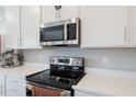 Contemporary kitchen with stainless steel appliances, sleek countertops, and white cabinetry at 2821 Cathy Blvd, Winter Haven, FL 33880