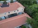 An aerial view showing the backyard of a townhouse with a screened-in patio at 2901 Puerta Del Sol Blvd, Kissimmee, FL 34744