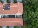 An aerial view of a townhouse featuring a terracotta-colored tile roof and screened in porch at 2901 Puerta Del Sol Blvd, Kissimmee, FL 34744