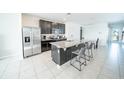 Stylish kitchen with stainless steel appliances, center island, and an adjacent dining area at 3451 Monaco Ln, Davenport, FL 33897