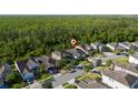 An aerial view displays a well-planned residential neighborhood surrounded by nature and lush green forest at 3890 Prairie Reserve Blvd, Orlando, FL 32824
