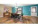 Bright dining room with wood floors, a modern table set, and an accent wall, filled with natural light at 4091 Lippman Rd, St Cloud, FL 34772