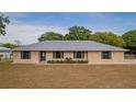 Charming single-story home with brick facade, metal roof, blue shutters, and a neatly kept front yard at 4091 Lippman Rd, St Cloud, FL 34772