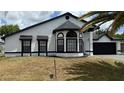 Charming single-Gathering home featuring a clean white exterior and dark accents, along with an attached two-car garage at 414 Otter Creek Dr, Kissimmee, FL 34743