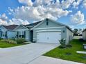 Beautiful single-story home featuring a manicured lawn and a convenient two-car garage at 4373 Deleon St, Haines City, FL 33844