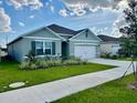 A charming single-story house boasts a well-kept lawn and a practical two-car garage at 4373 Deleon St, Haines City, FL 33844